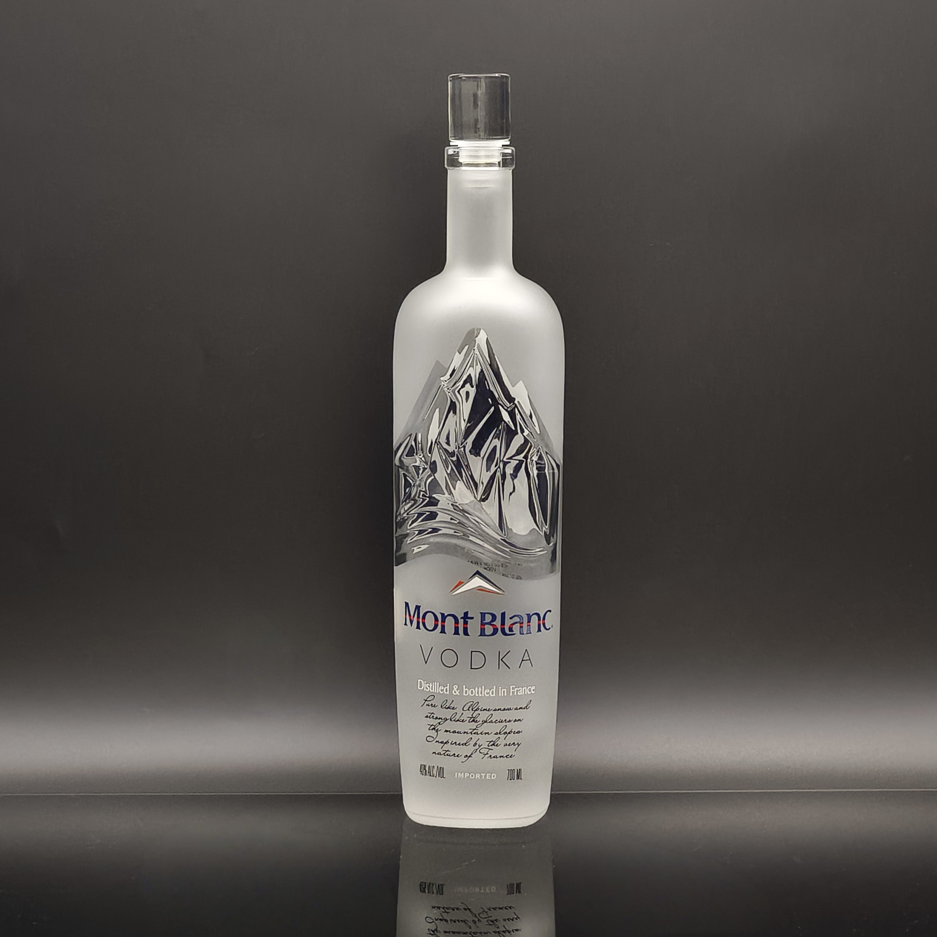 Custom OEM spirit glass bottle design with frosting and embossed logo options